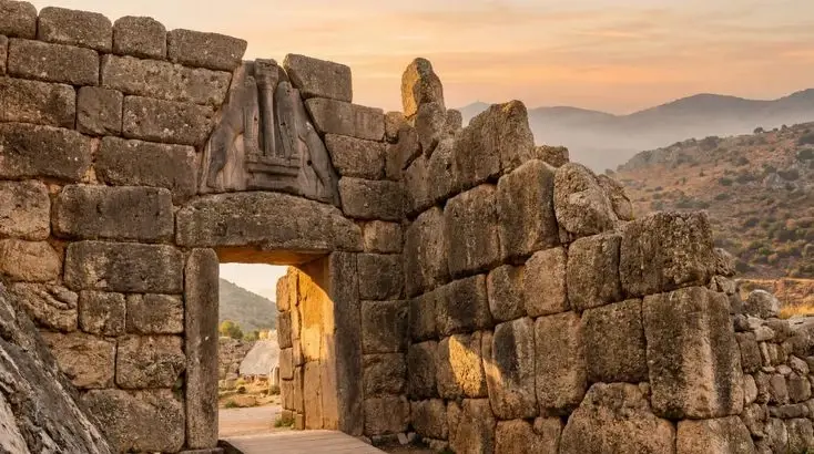  ancient Lion Gate entrance to the archaeological site of Mycenae in Greece at sunset. 